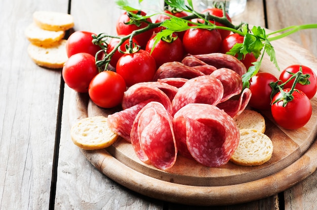 Fresh salami with tomato and bread