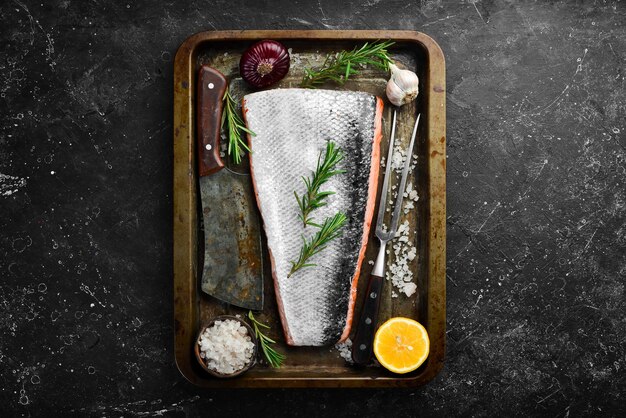 Fresh salmon fillet in a metal baking dish Seafood Top view Free space for text