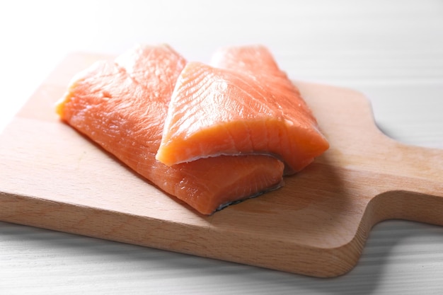 Fresh salmon fillet on wooden cutting board