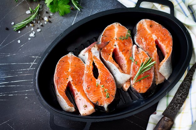 Fresh salmon pickled for a barbecue on a castiron frying pan Proper nutrition Copy space