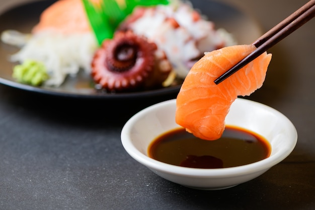 Fresh salmon sashimi and a soy bowl