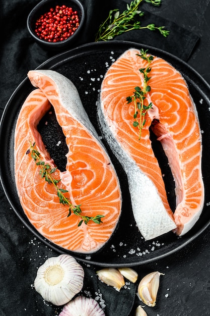 Fresh salmon steak on a plate with spices.