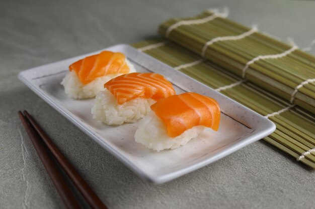 Fresh Salmon sushi nigiri served on ceramic plate