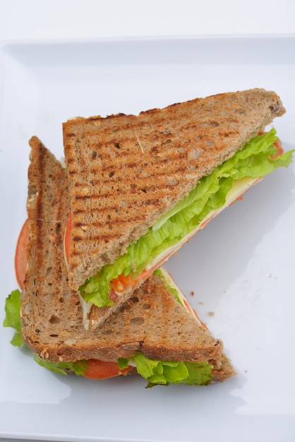 fresh sandwich close up with vegetables and meat fish isolated on white background