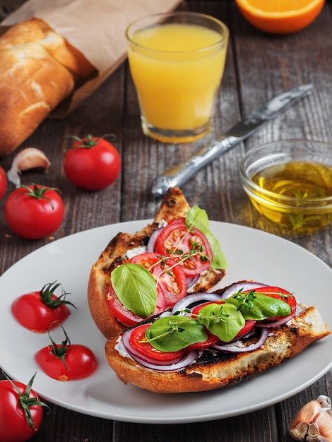 Fresh sandwiches baguette with tomatoes, vegetables and olive oil.