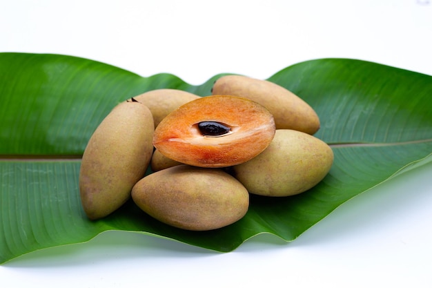 Fresh sapodilla fruit green leaf on white background