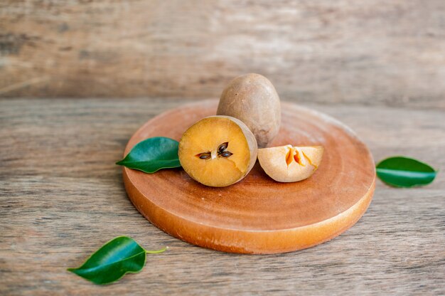 오래 된 나무 배경에 신선한 sapodilla 과일