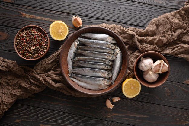 Fresh sardines on rustic wooden background