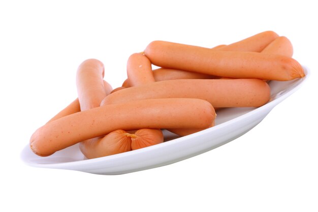 Photo a fresh sausage on white plate . isolated over white.