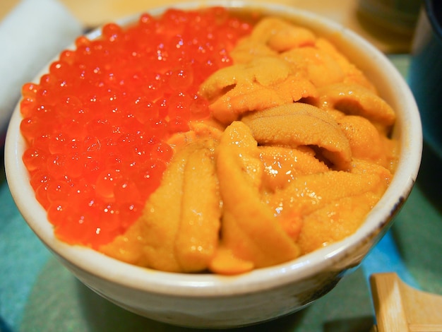 Fresh sea urchin and salmon eggs bowl or unidon Japanese traditional food