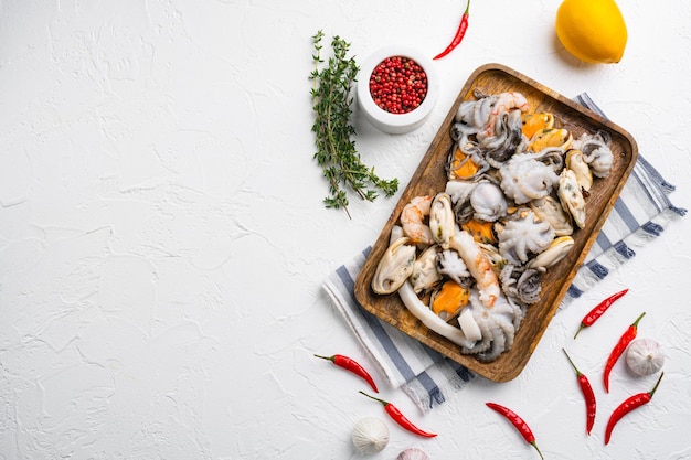 Fresh seafood arrangement mussels, squid octopus set, on white stone table background, top view flat lay, with copy space for text