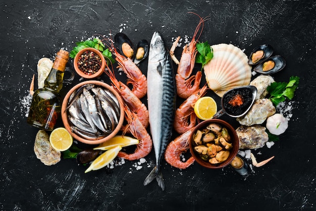 Fresh seafood on a stone background Fish shrimp mussels caviar Top view Free copy space