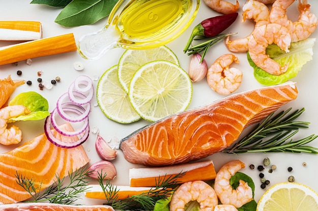 Fresh seafood on a table with spices vegetables and olive oil fresh and smoked salmon shrimp and crab sticks for a supermarket or fish sushi restaurant