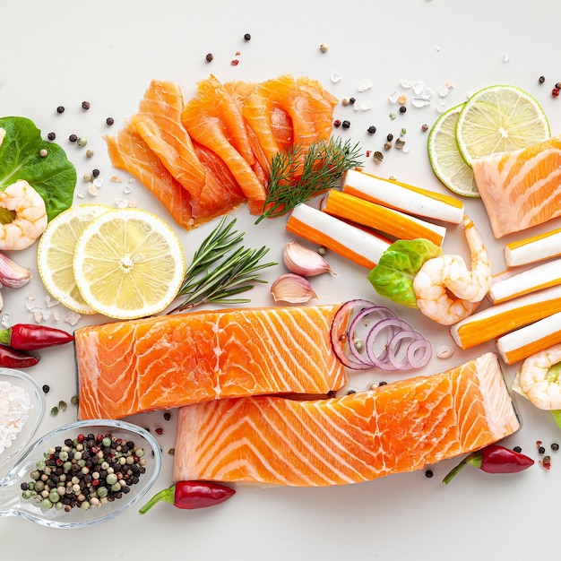 Fresh seafood on a table with spices vegetables and olive oil fresh and smoked salmon shrimp and crab sticks for a supermarket or fish sushi restaurant