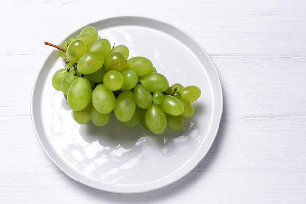 Fresh seasonal grapes in plastic plate