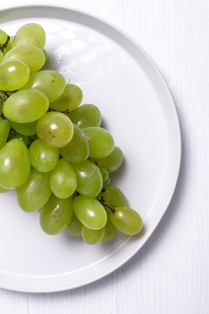 Fresh seasonal grapes in plastic plate