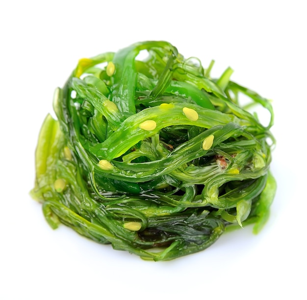 Fresh seaweed salad isolated on white.