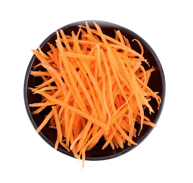 fresh shredded carrots in bowl on white 