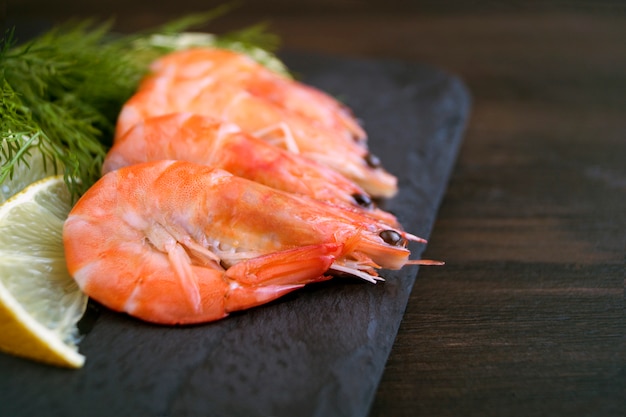 Fresh shrimp blackboard with lemon and dill.