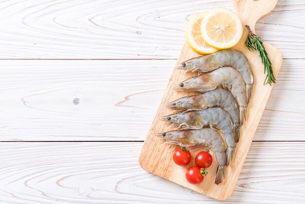 fresh shrimps or prawns raw on wooden board