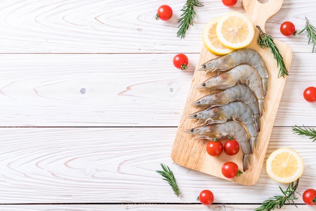 fresh shrimps or prawns raw on wooden board