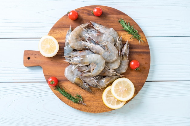 fresh shrimps or prawns raw on wooden board