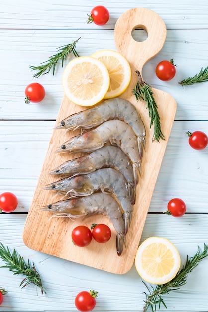 fresh shrimps or prawns raw on wooden board