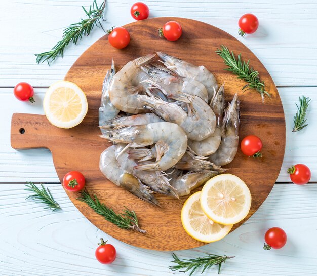 fresh shrimps or prawns raw on wooden board