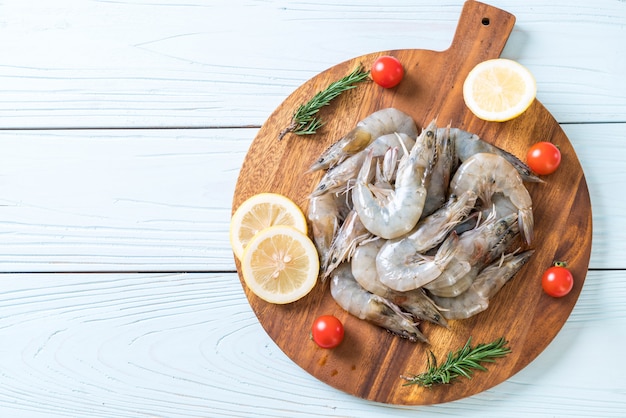 fresh shrimps or prawns raw on wooden board