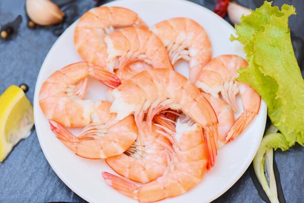 Fresh shrimps served on white plate boiled peeled shrimp prawns cooked in the seafood restaurant top view