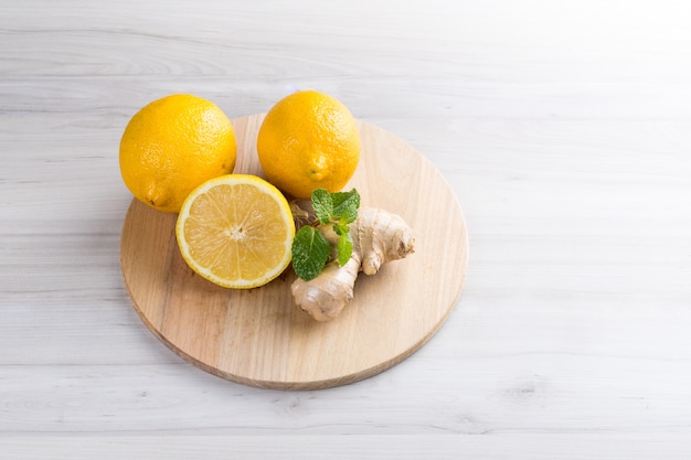 Fresh sicilian lemon slice with ginger on a white wooden