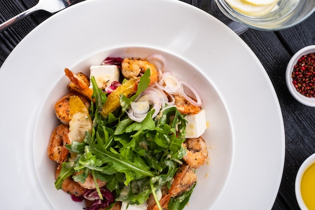 Fresh Sicilian Salad with shrimps, arugula, cheese and ripe orange slices.