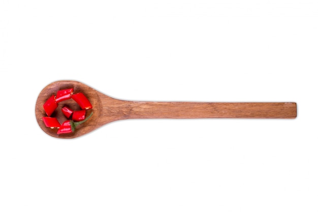 Fresh sliced chili pepper on wooden spoon isolated on white 