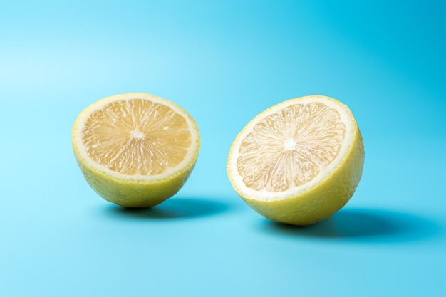 Photo fresh sliced lemon on blue surface.