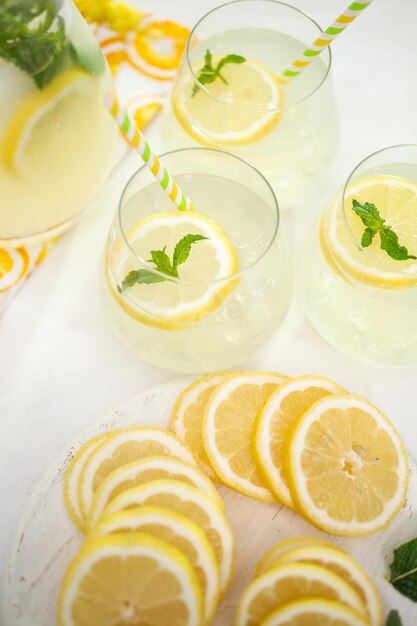 Fresh sliced lemon on a white wood cutting board.