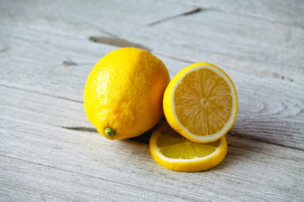 Fresh sliced lemon on wooden natural background