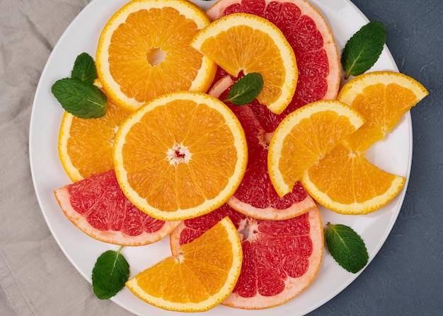 fresh sliced mixed citrus fruits on table. background, concept of healthy eating, dieting, top view