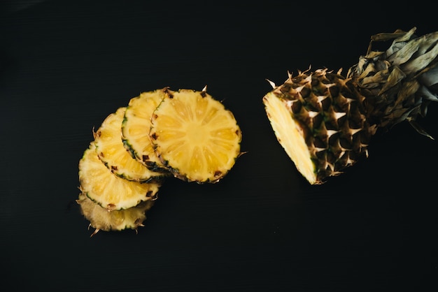 Fresh sliced pineapple on a dark background