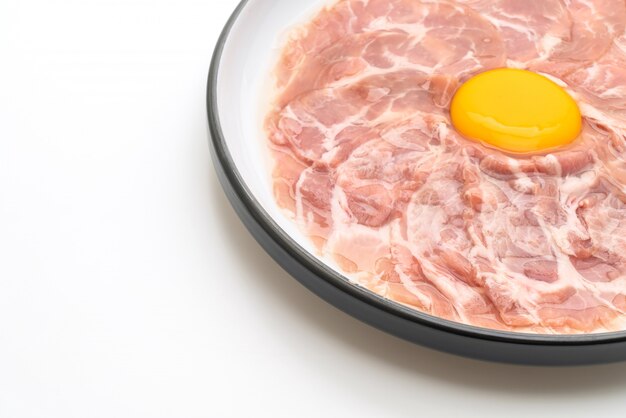 fresh sliced pork raw with egg for cooking