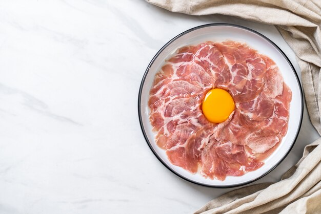 fresh sliced pork raw with egg