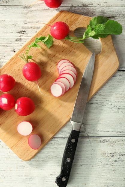 Fresh sliced radishes on cutting board close up