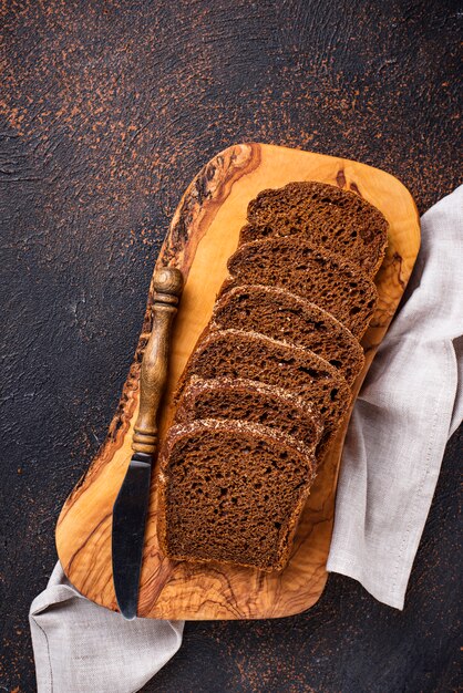 Fresh sliced rye bread on rusty background