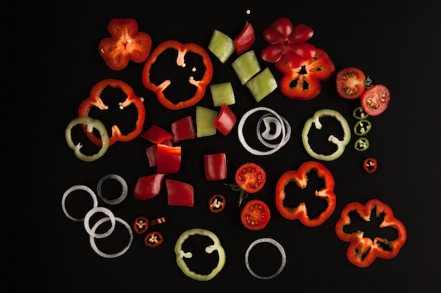 Fresh sliced vegetables close up on black background