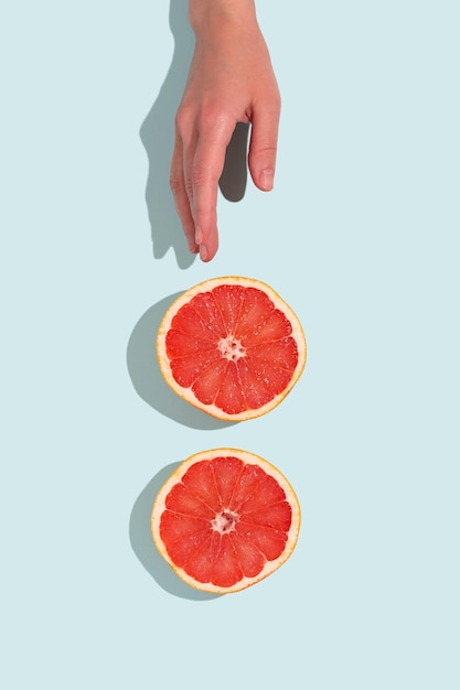 Fresh slices of grapefruit Minimal food creative concept on turquoise pastel background