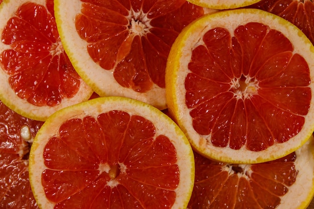 Fresh slices of grapefruits as background