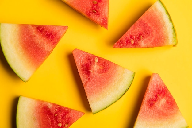 Fresh slices of summer water melon on a bright yellow background