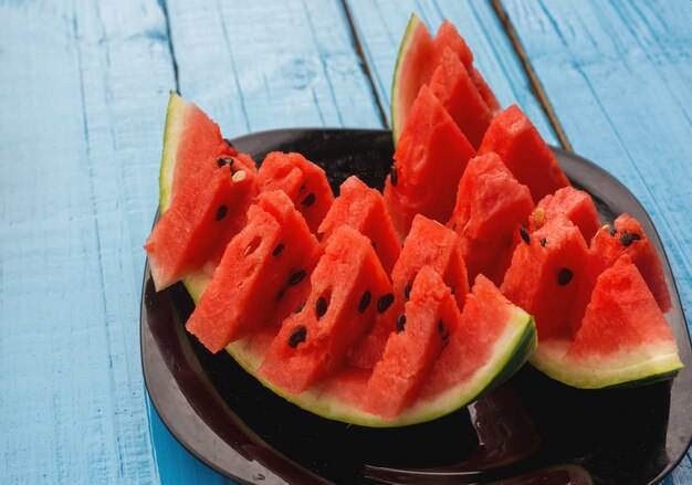 Fresh slices of watermelon on a blue background