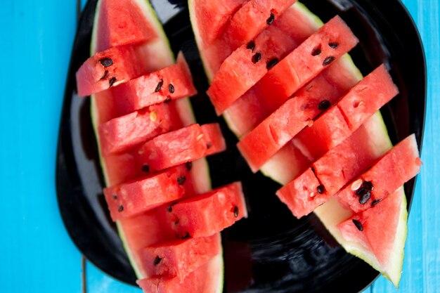 Fresh slices of watermelon on a blue background