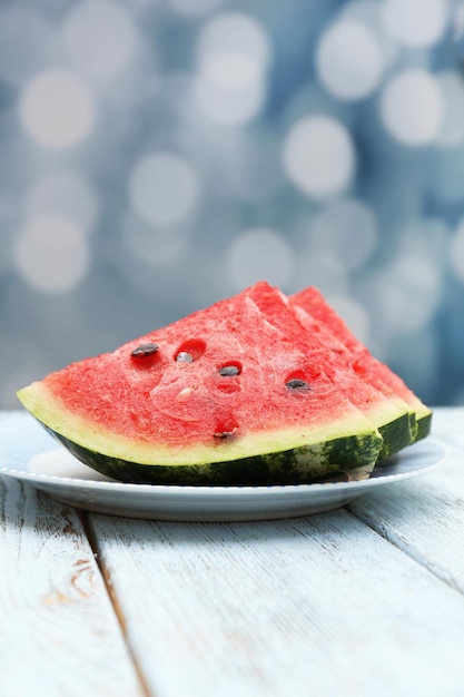 Fresh slices of watermelon on table on bright background