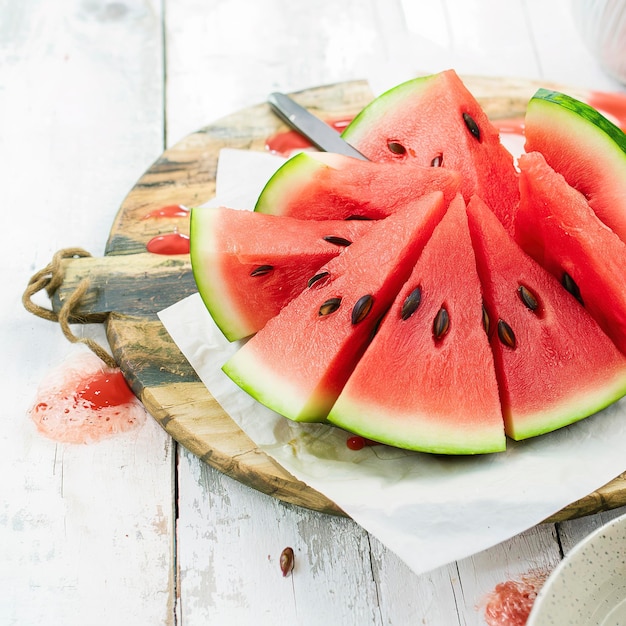 Fresh slices of watermelon on a wooden background